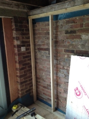 Stud wall goes up...